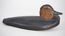 Lowhead black duck wingduck, similar to the decoys photographed on a sinkbox rig on the Platte River in Nebraska. Finely carved, inletted neck seat, excellent original paint, a rare find, ca. 1895.